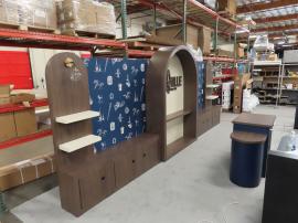 Custom Wood Fabrication Inline Exhibit with (1) Center Arch, (2) Side Arches, Shelves, Locking Backwall Cabinets, Fabric Graphics, and Custom Reception Counter with Locking Storage -- View 2